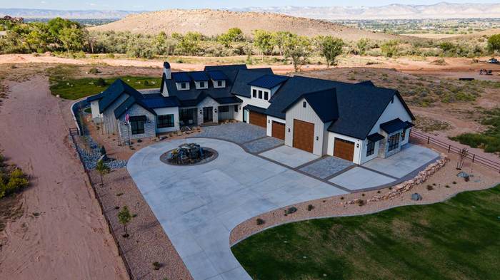 Front aerial of the Soaring Eagle Residence with circular drive and water feature